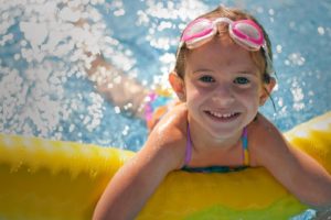 portrait-of-girl-smiling-and-swimming-in-pool.jpg